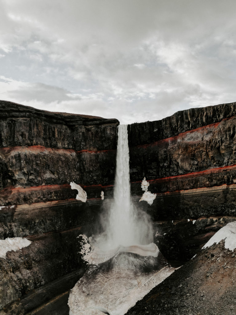 Waterfall with red layers of minderals