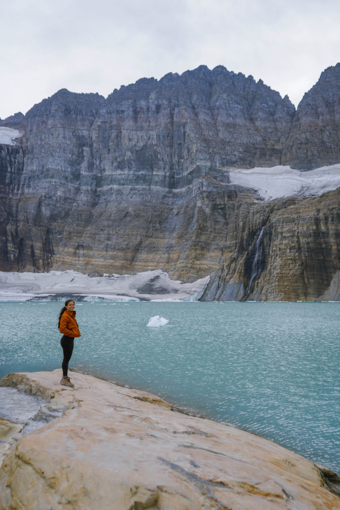 Girl standing in front of Grinnell Glacier - the best hike in Glacier National Park