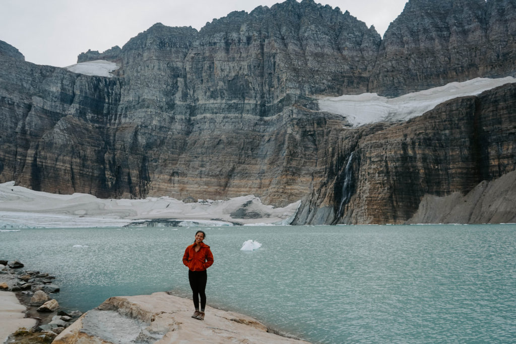Girl standing in front of Grinnel Glacier - the best hike in Glacier National Park