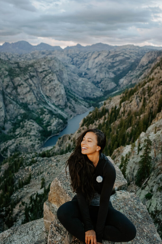 subject in the middle with views of the canyon and lake in the background