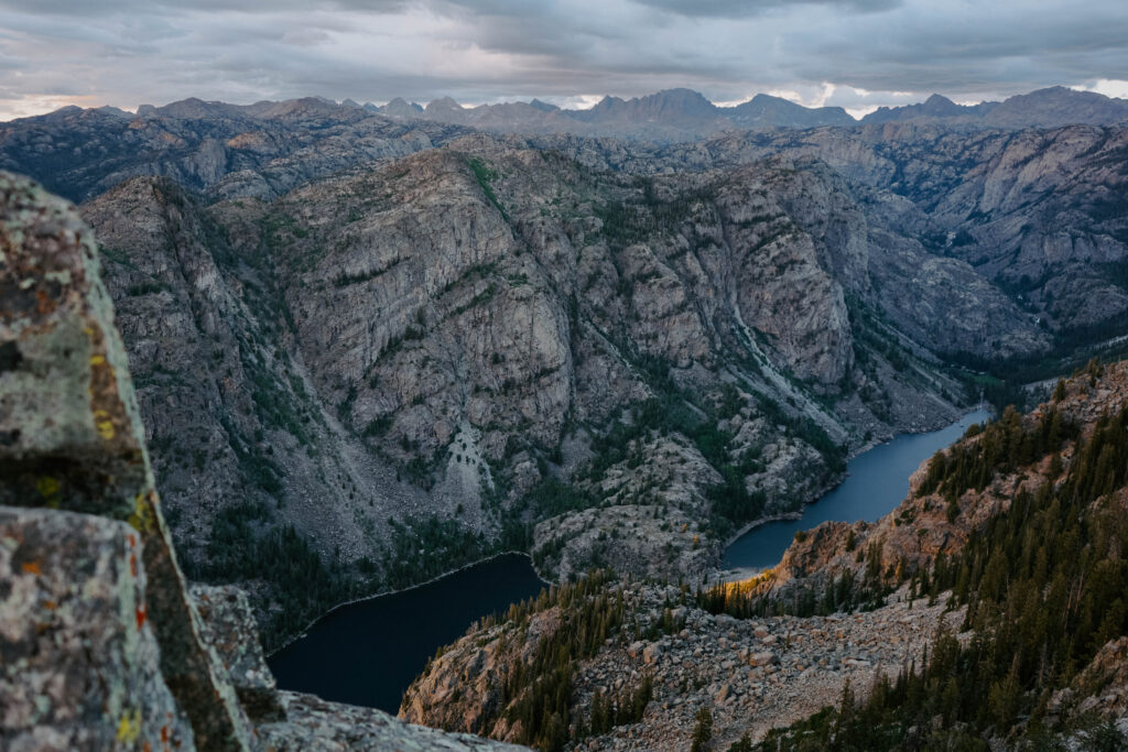 expansive views of the Wind River Range and a lake below the canyon