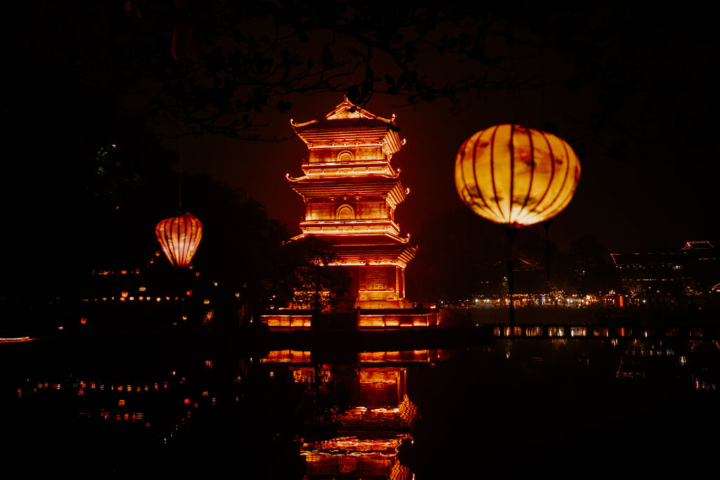 Lantern and ancient temple lit up at night in Ninh Binh