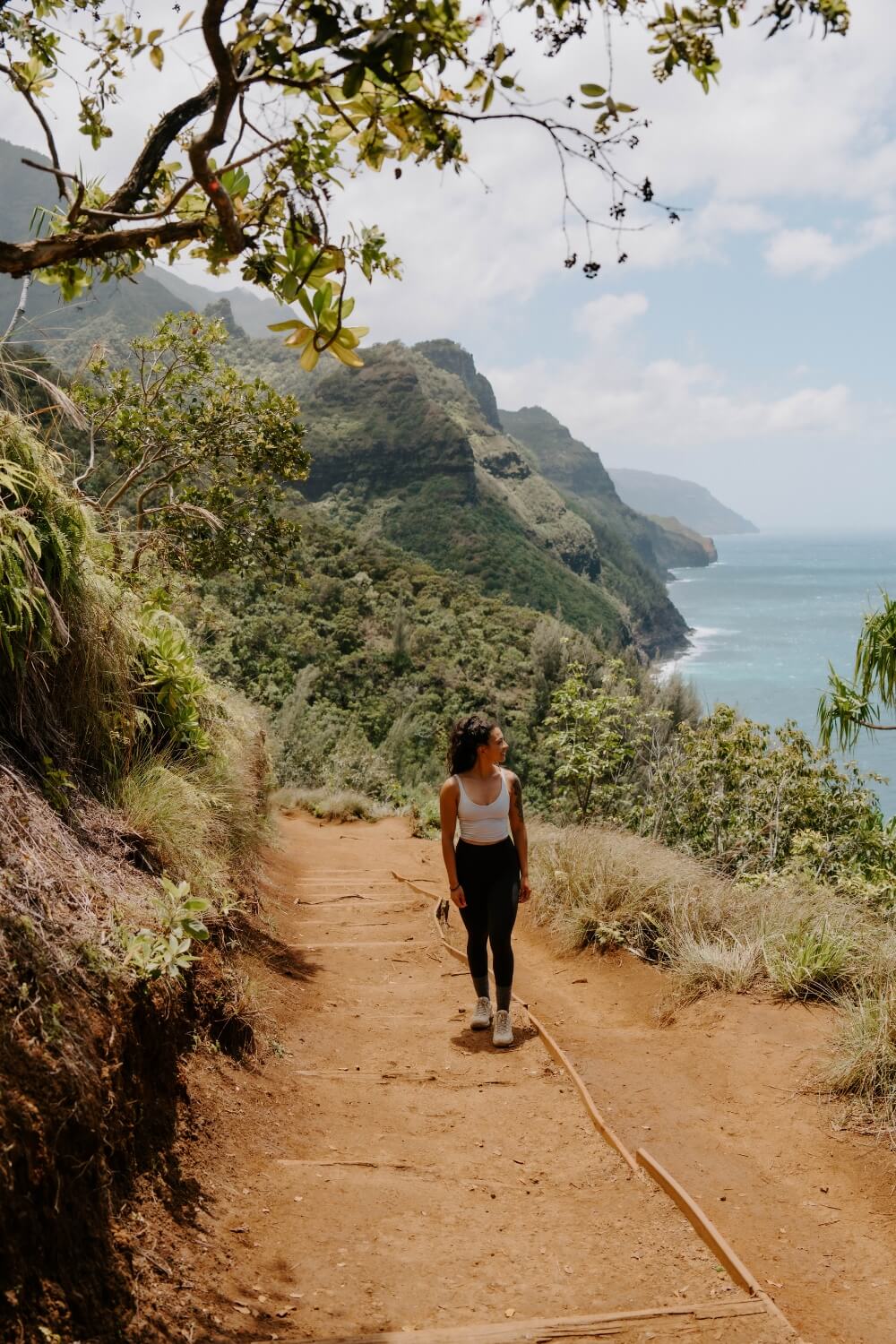 female hiker walking along kauai kalalau trail