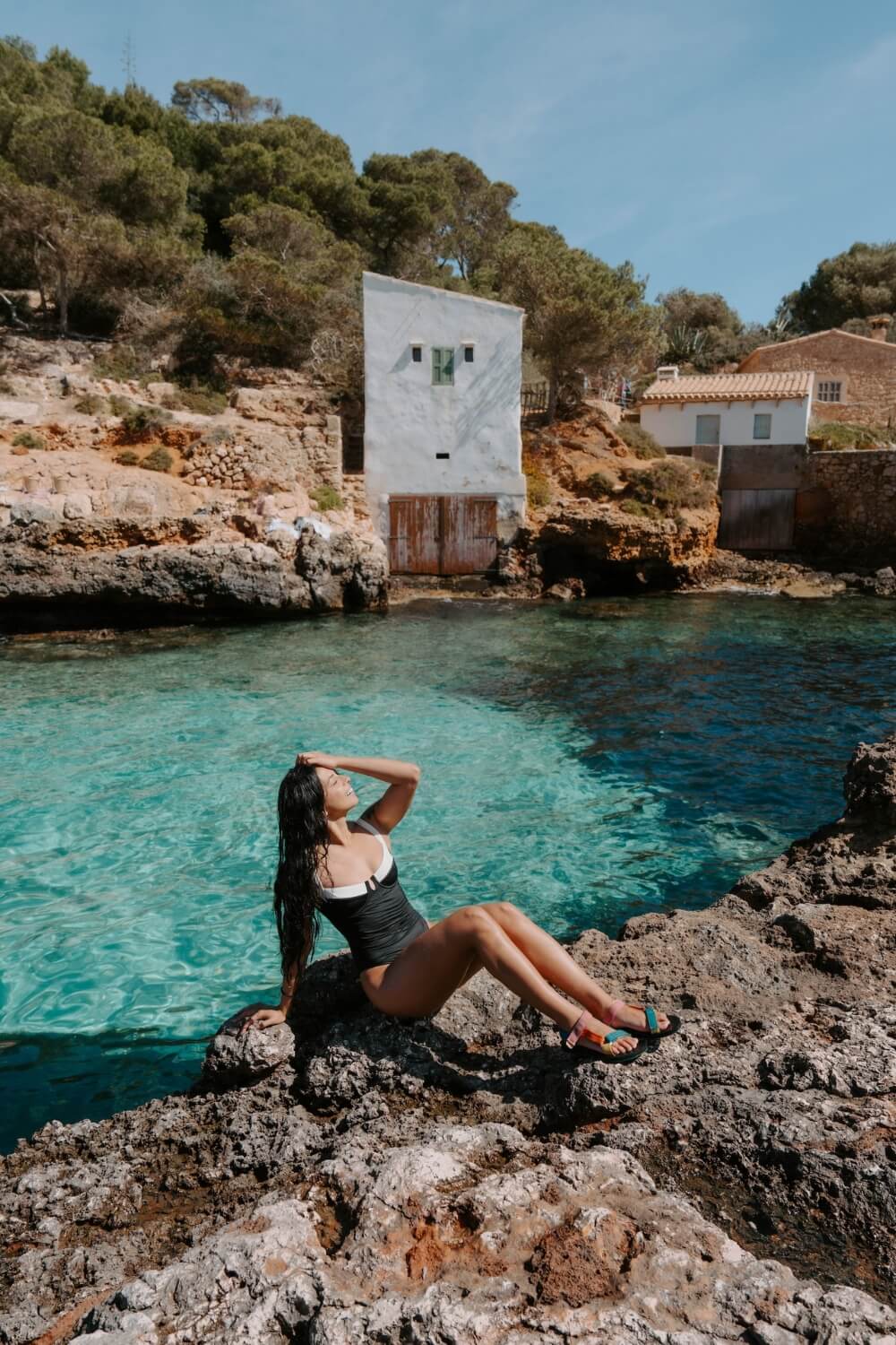 girl in a black swimsuit sunbathing in Mallorca Cala S’Almonia