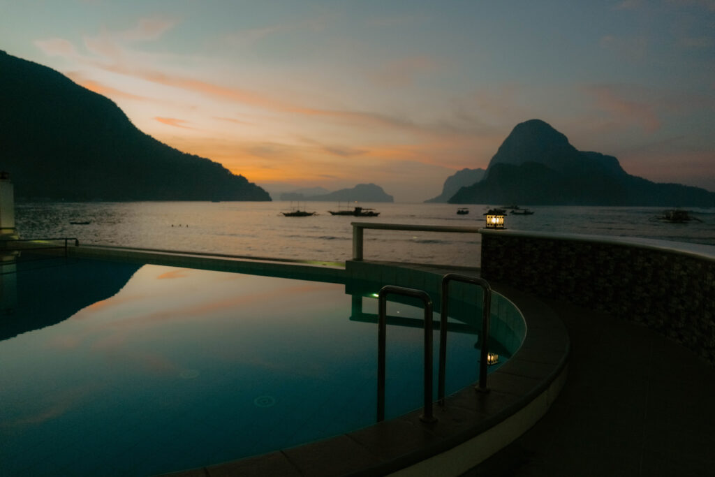 pool with a view of the ocean and mountain 