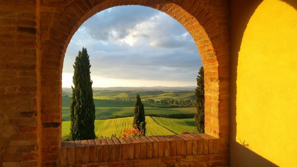 Arch overlooking rolling hills in tuscany