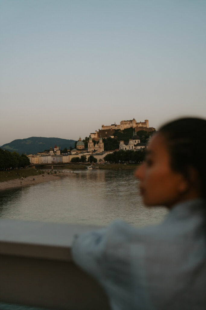 girl looking over hohenwerfen castle austria