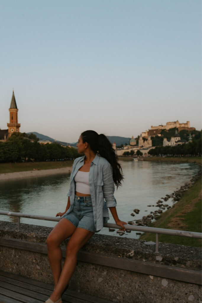 girl standing in front of a lake at wolfgangsee austria