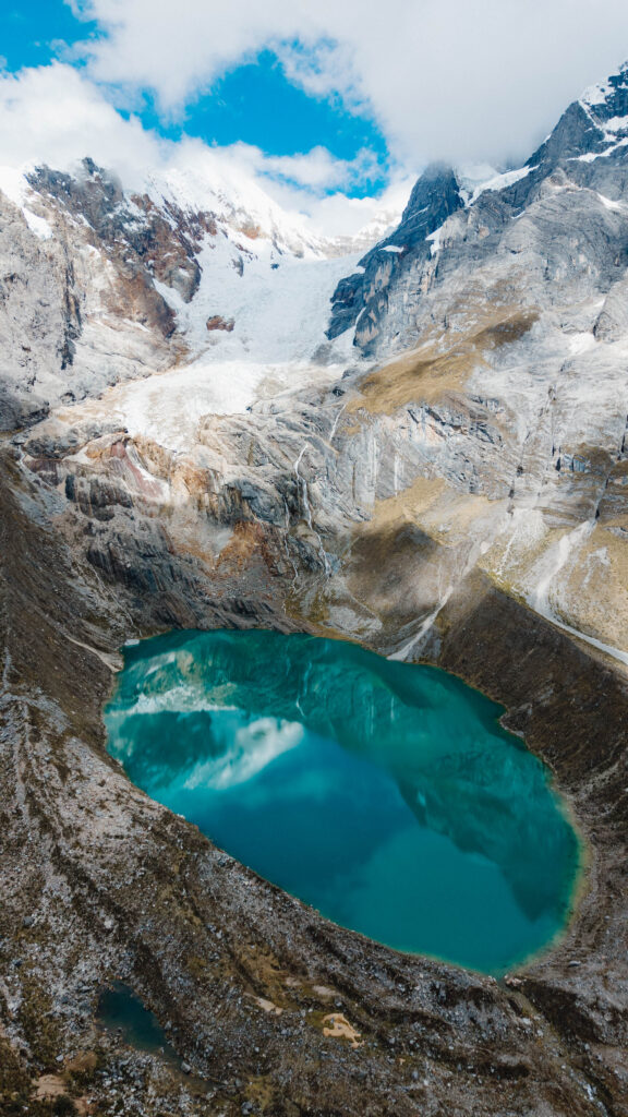 Drone shot of blue lake with glacier